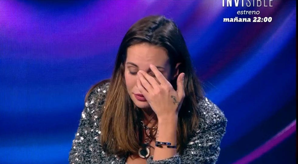 a woman with her hand on her face