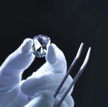 jeweller inspecting replica diamonds with gloved hand
