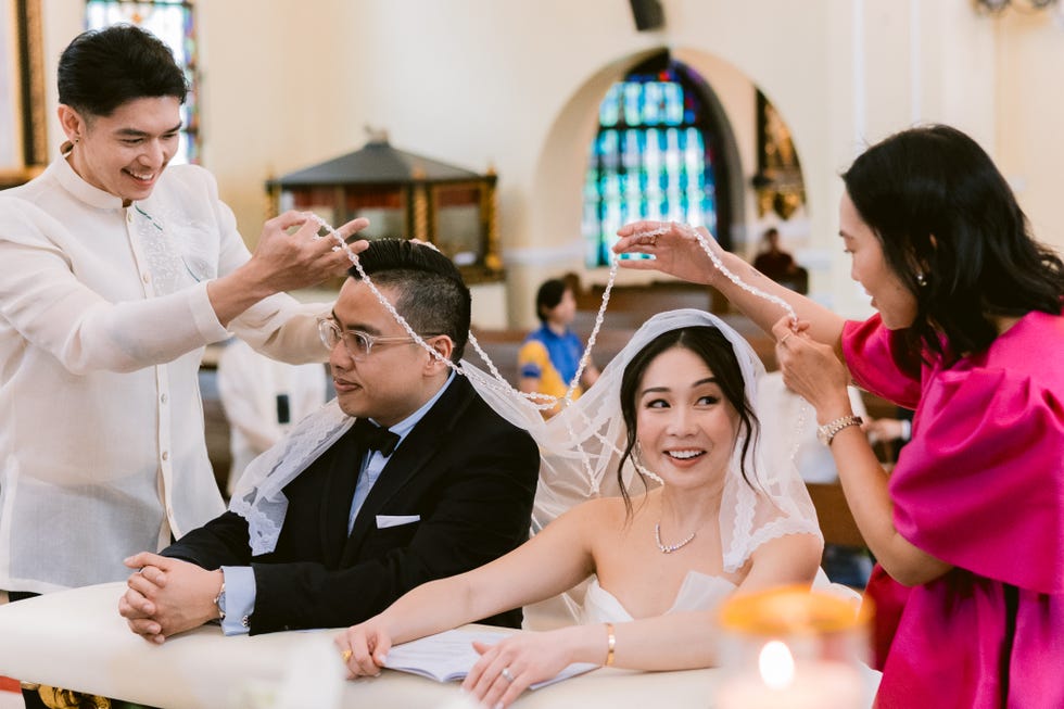 a group of people cutting a cake