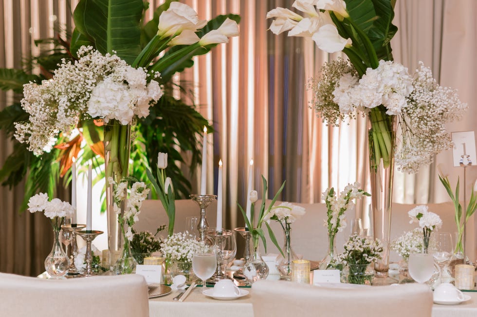 a table with flowers and candles