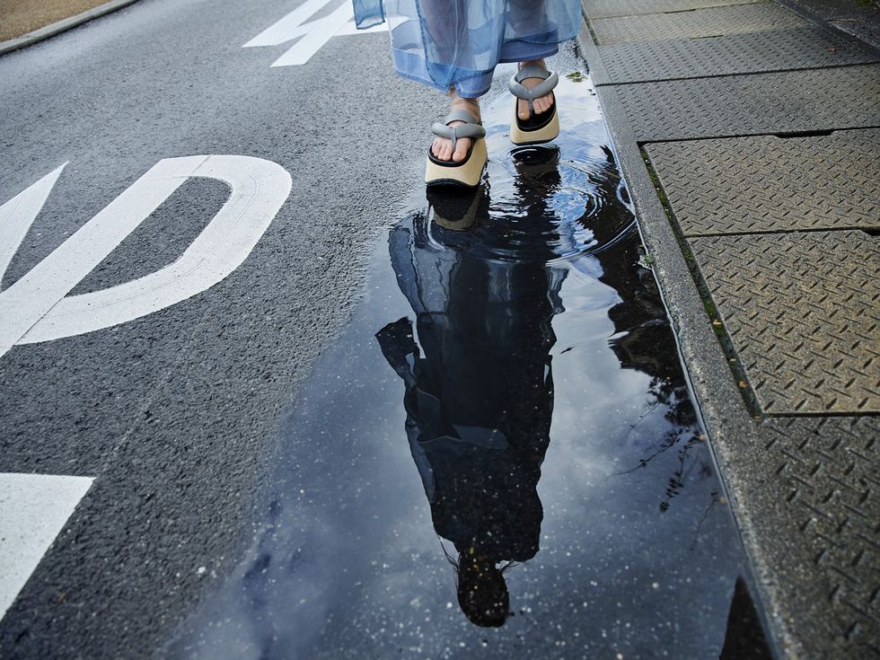 Water, Reflection, Road surface, Pedestrian, Puddle, Leg, Shadow, Footwear, Line, Infrastructure, 