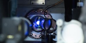 glimpse inside the vacuum chamber of an atomic clock at glowing strontium atoms