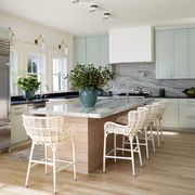 kitchen, green cabinets, black countertops, marble kitchen island, white kitchen bar stools