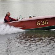 jim eicher and his g 36 gentleman's racer boat on a small lake