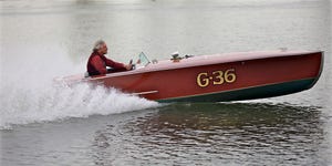 jim eicher and his g 36 gentleman's racer boat on a small lake