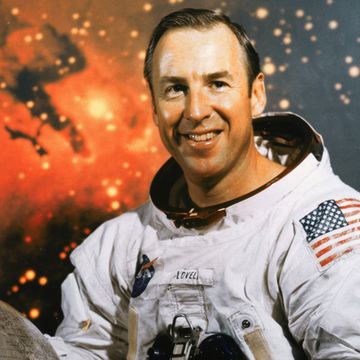 a male astronaut smiles as he poses for a photo