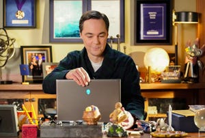 a person sitting at a table with a laptop