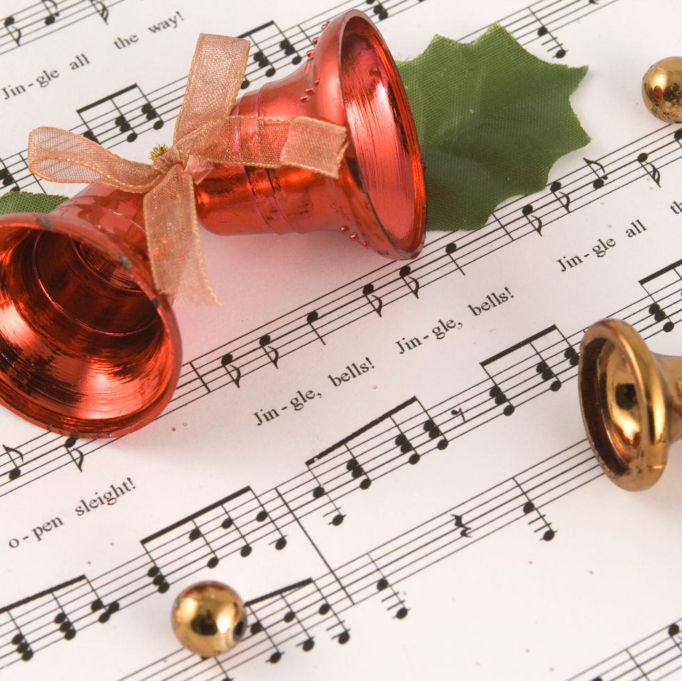 jingle bells sheet music with a pair of red bells and holly leaves