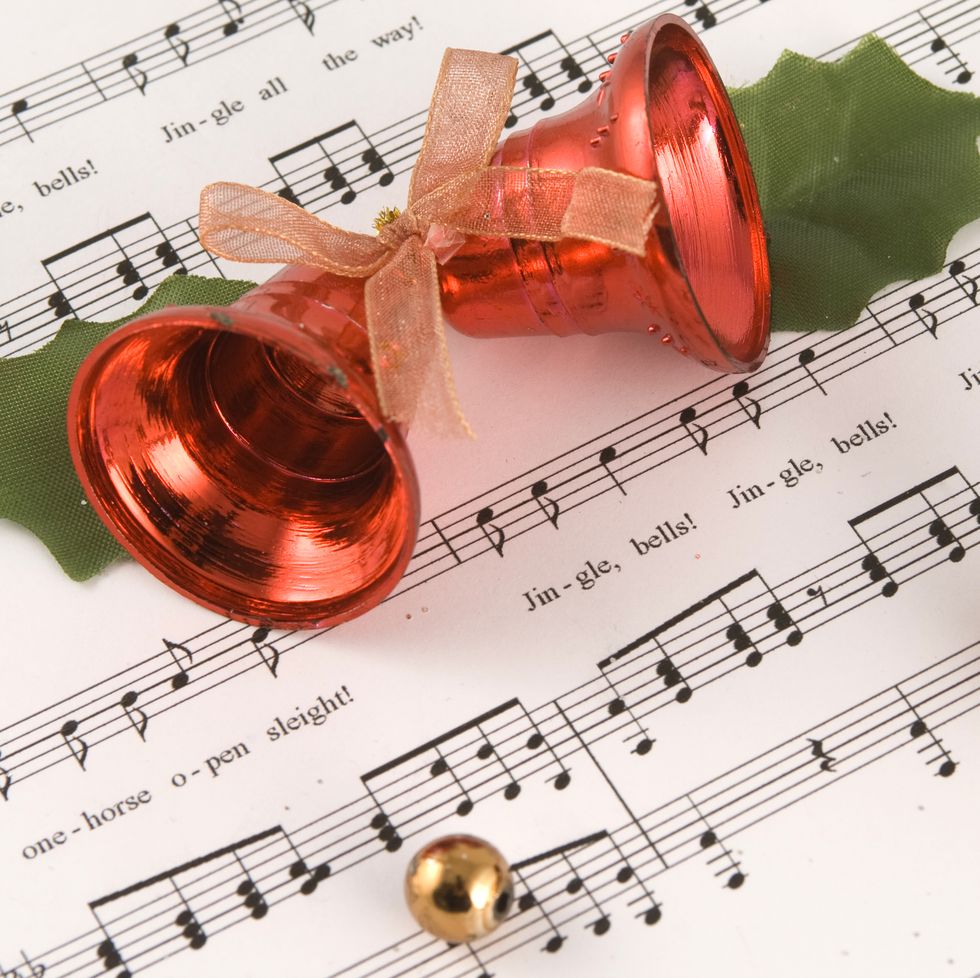 jingle bells sheet music with a pair of red bells and holly leaves