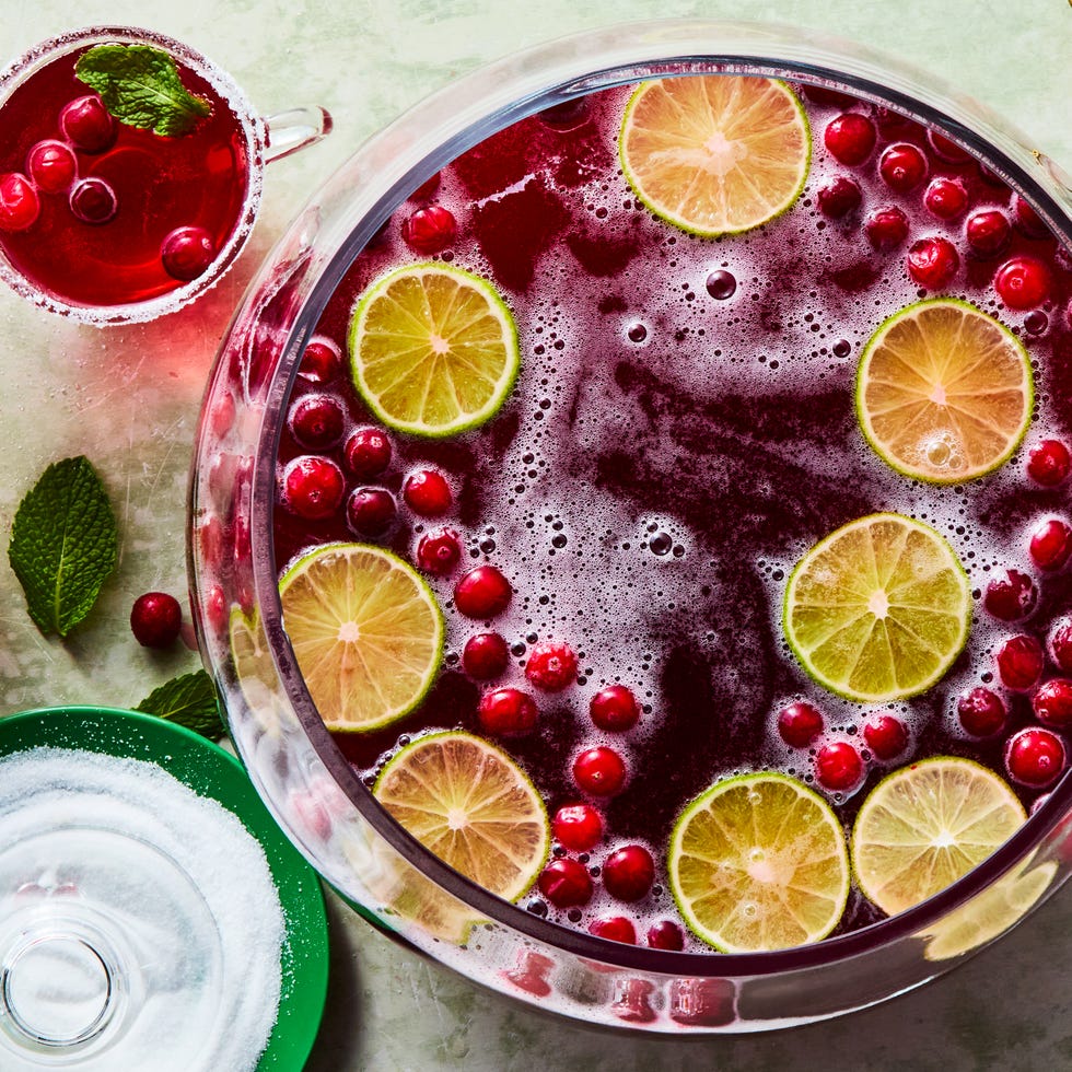 bowl of punch with cranberries and lime