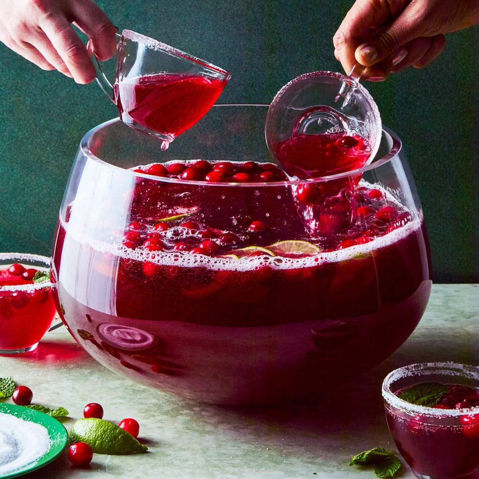 bowl of punch with cranberries and lime