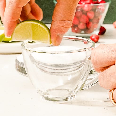 red holiday punch garnished with cranberries and lime
