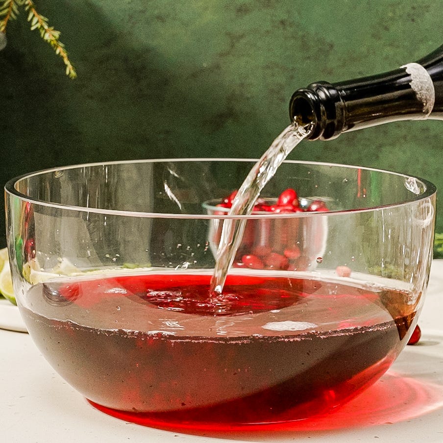 red holiday punch garnished with cranberries and lime