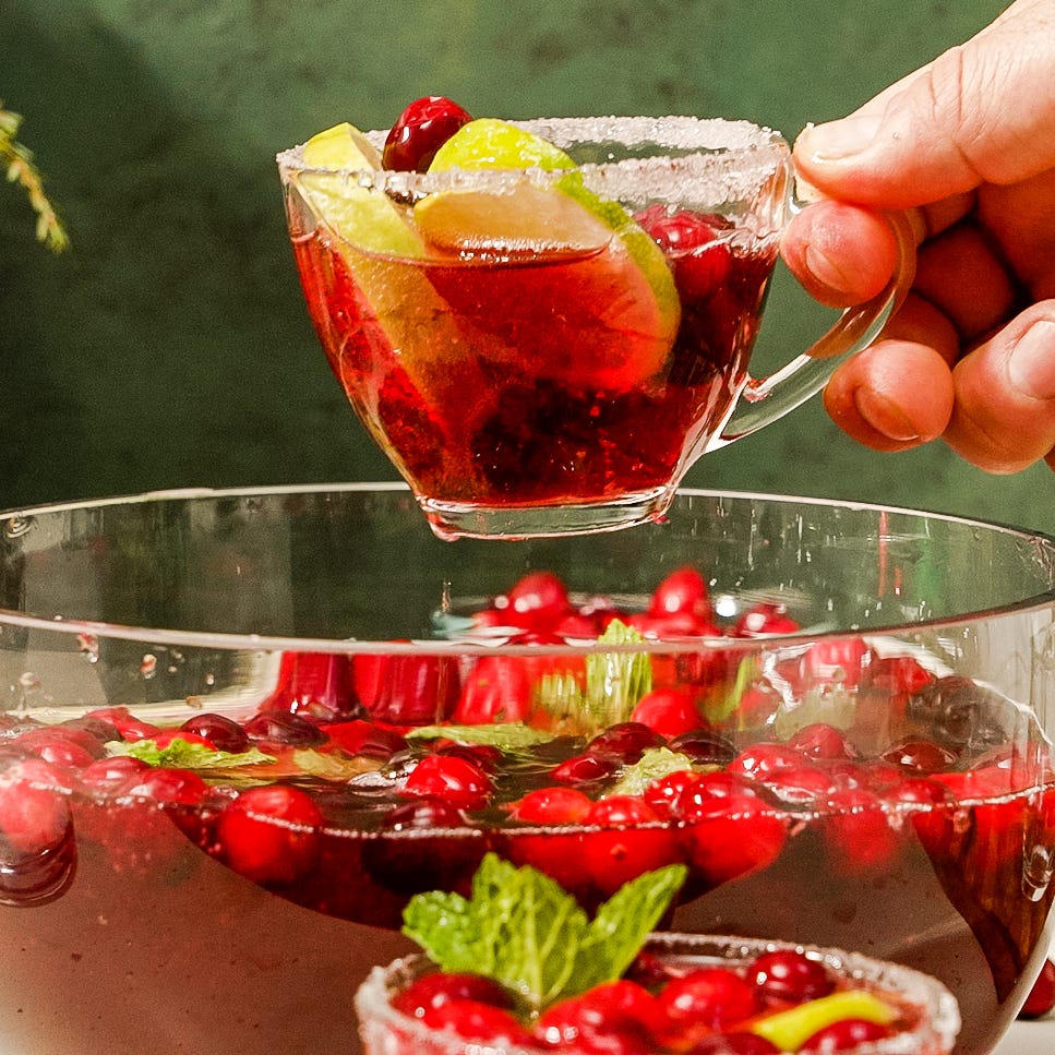 red holiday punch garnished with cranberries and lime