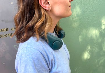 person wearing a portable fan around their neck