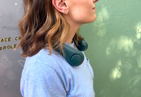 person wearing a portable fan around their neck