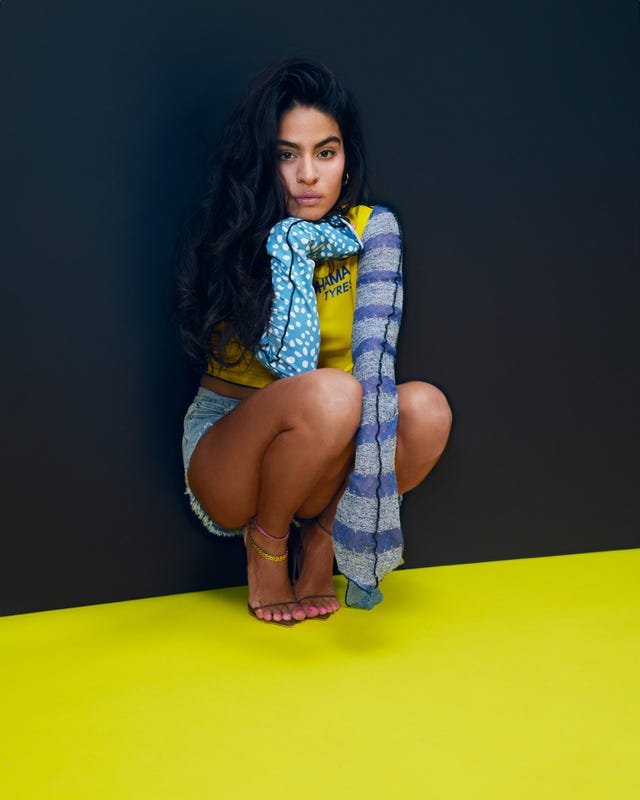 a woman in blue and yellow clothign crouching