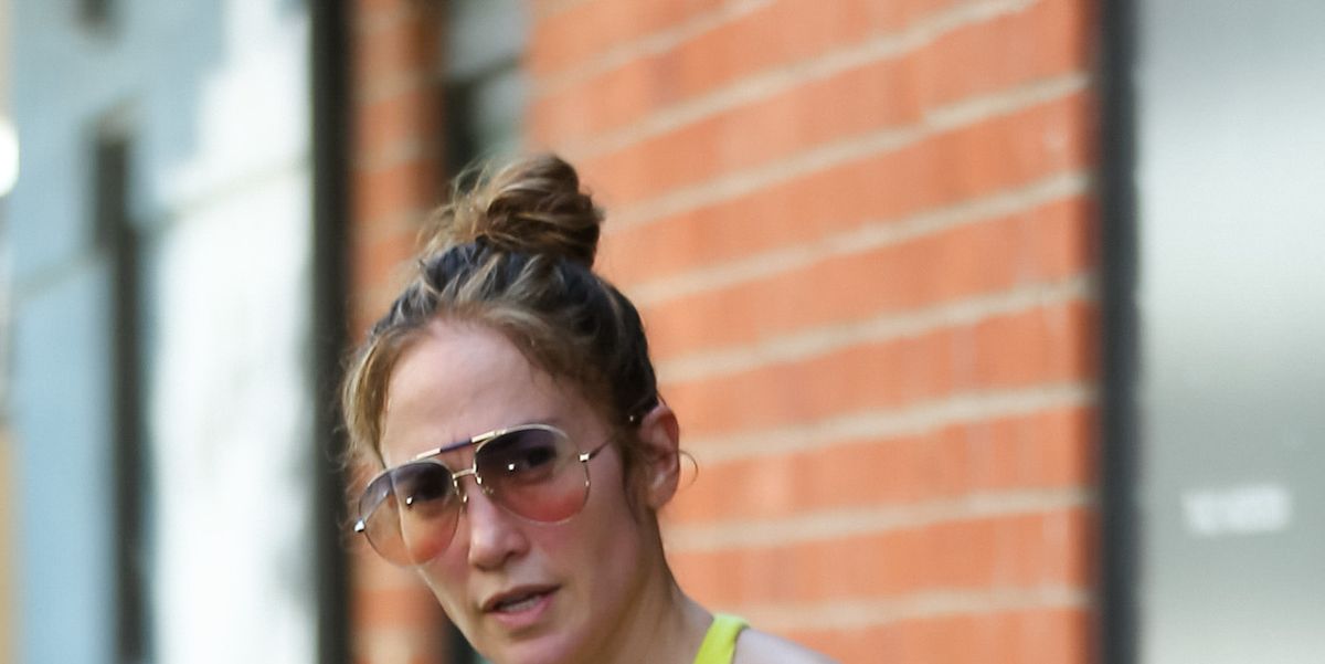 JLo works out in bright yellow gym wear and snake print leggings