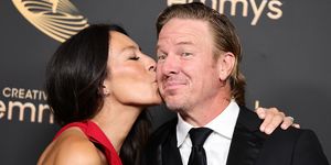 joanna gaines kisses chip gaines on the cheek during a red carpet event