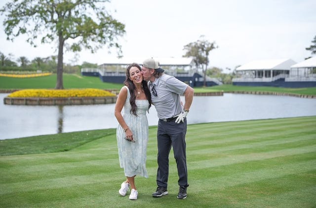 a couple sharing a moment on a golf course by a pond