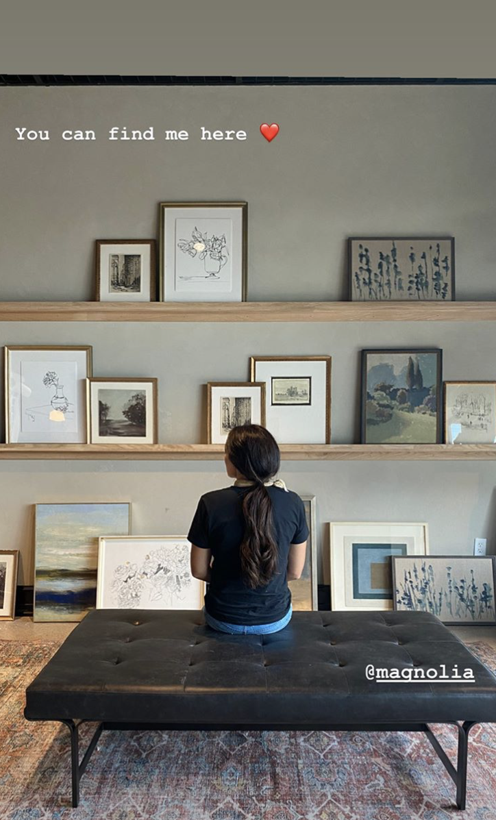 joanna gaines looking at her wall art display