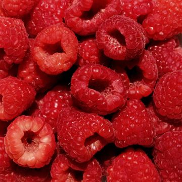 a close up of a pile of raspberries