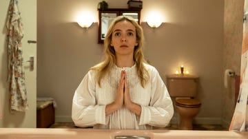 person in a bathroom performing a ritual or prayer