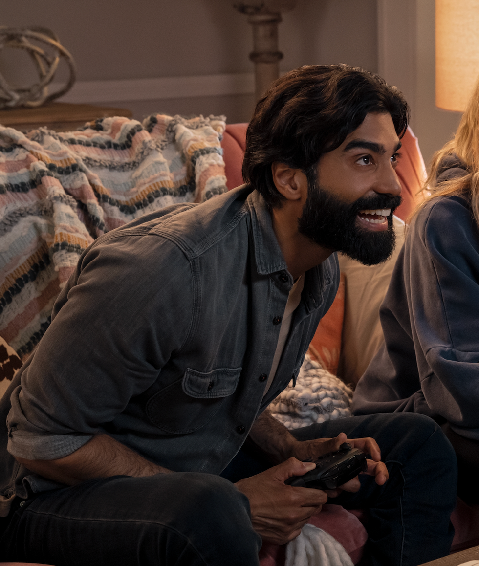 two people sitting together engaging in video gaming