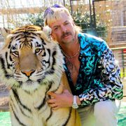 joe exotic poses with tiger