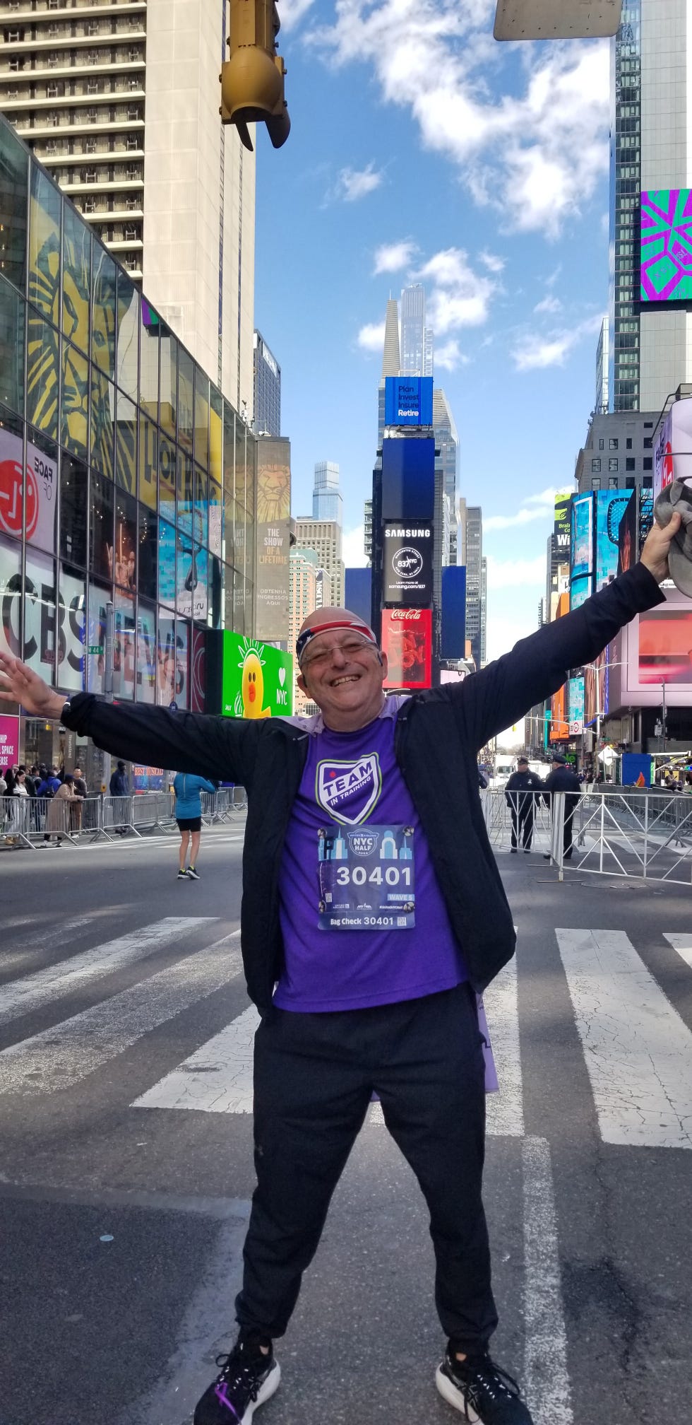 person celebrating in times square with city skyline and digital billboards in the background