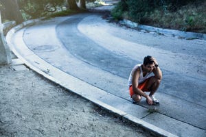 Jogger exhausted, taking break, Arroyo Seco Park, Pasadena, California, USA