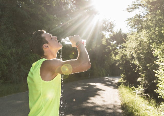 jogger in the park drinking water