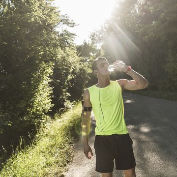 jogger in the park drinking water