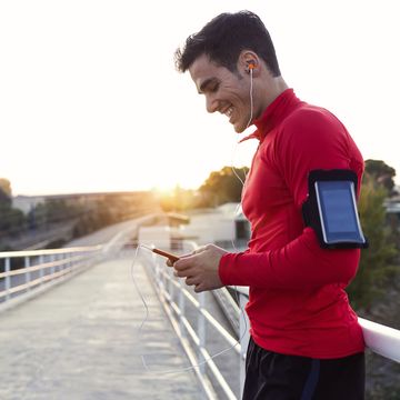 jogger with smartphone in arm pocket