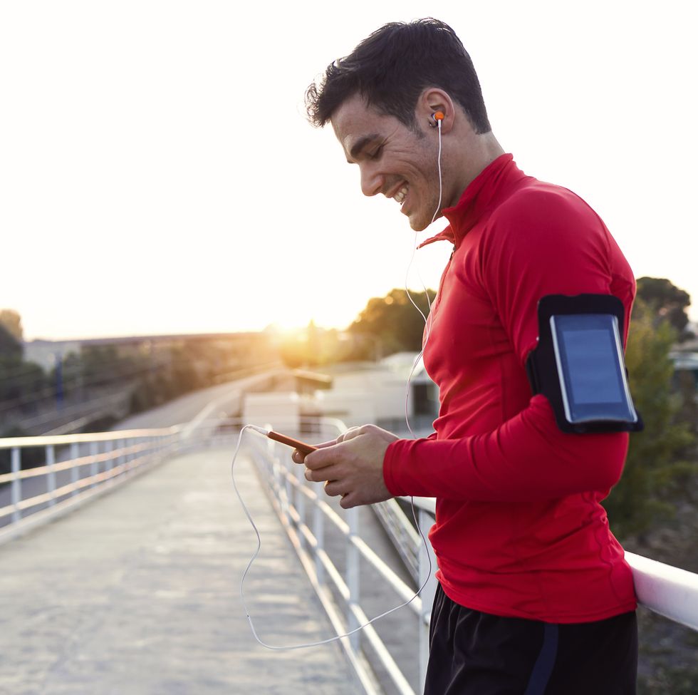 jogger with smartphone in arm pocket