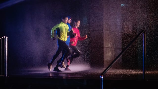 joggers running on rainy night