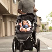 dad pushing baby in jogging stroller
