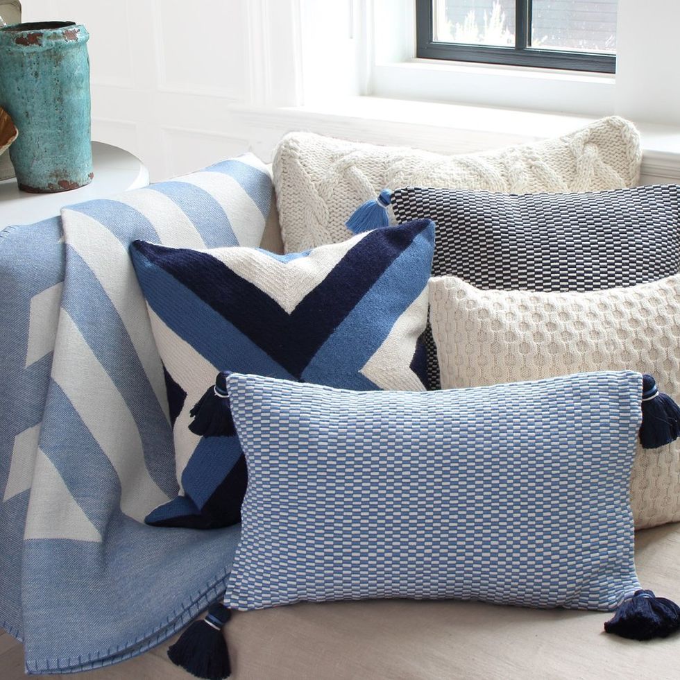 blue throws and pillows on a sofa