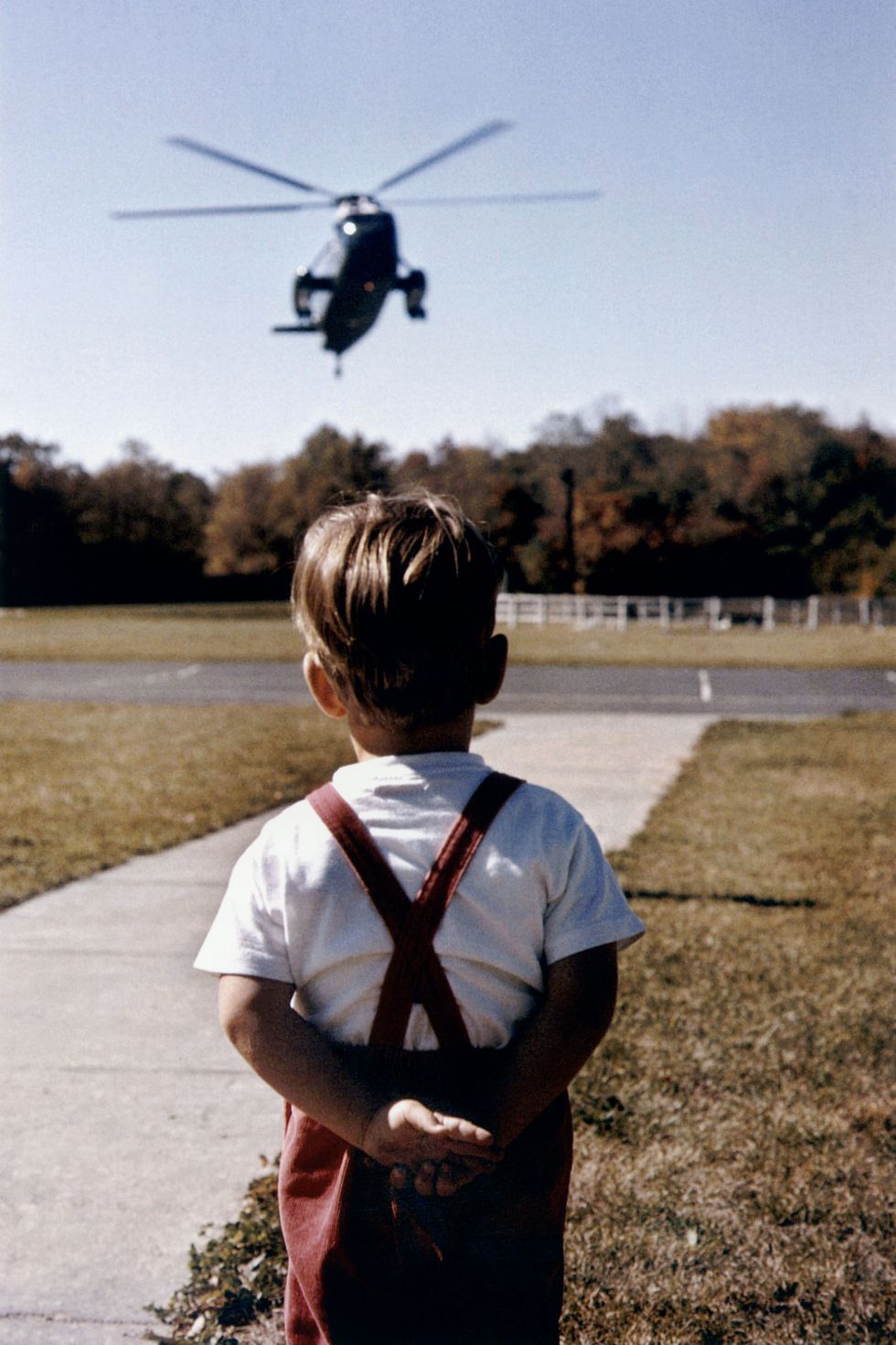 Young John Jr. patiently waiting the helicopter landing and arrival of his father, American President John F. Kennedy.