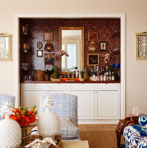 eclectic home bar with tortoise-print wallpaper and cabinets