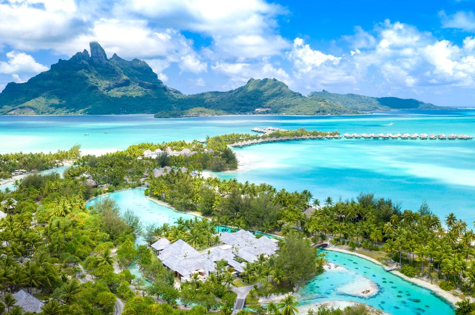 a beautiful tropical beach with bora bora in the background