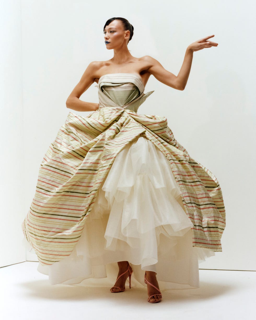 Fashion model showcasing a unique dress with layered fabric and a stylish silhouette