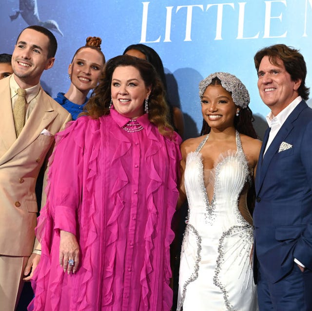 actors from the little mermaid embracing for a photo