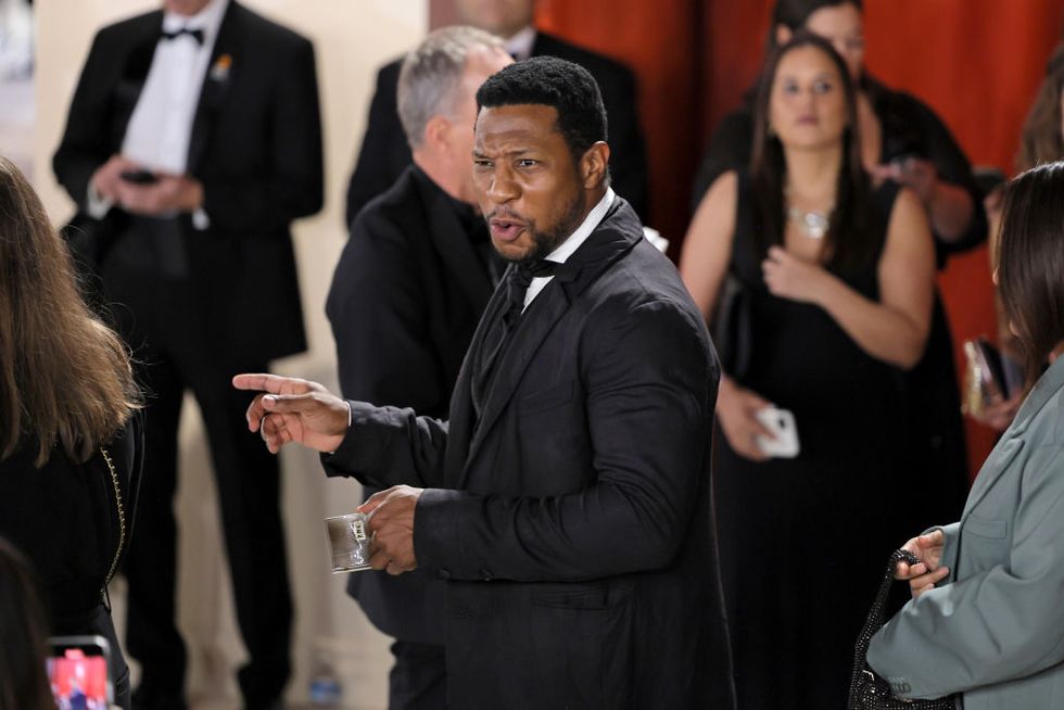jonathan majors pointing as he talks to someone off camera