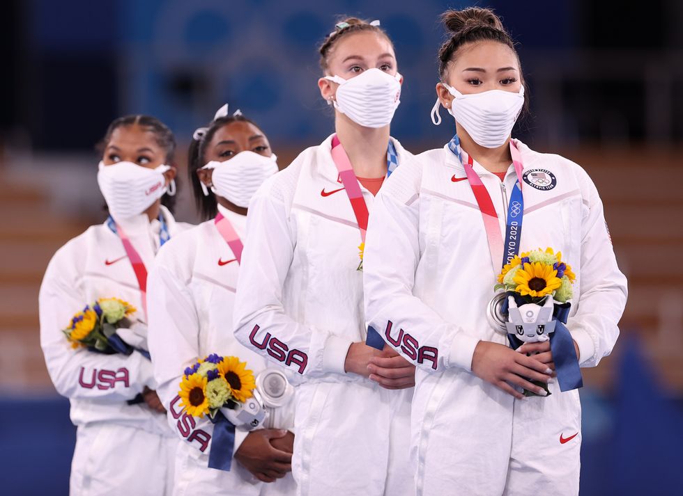 gymnastics team usa wearing white face masks
