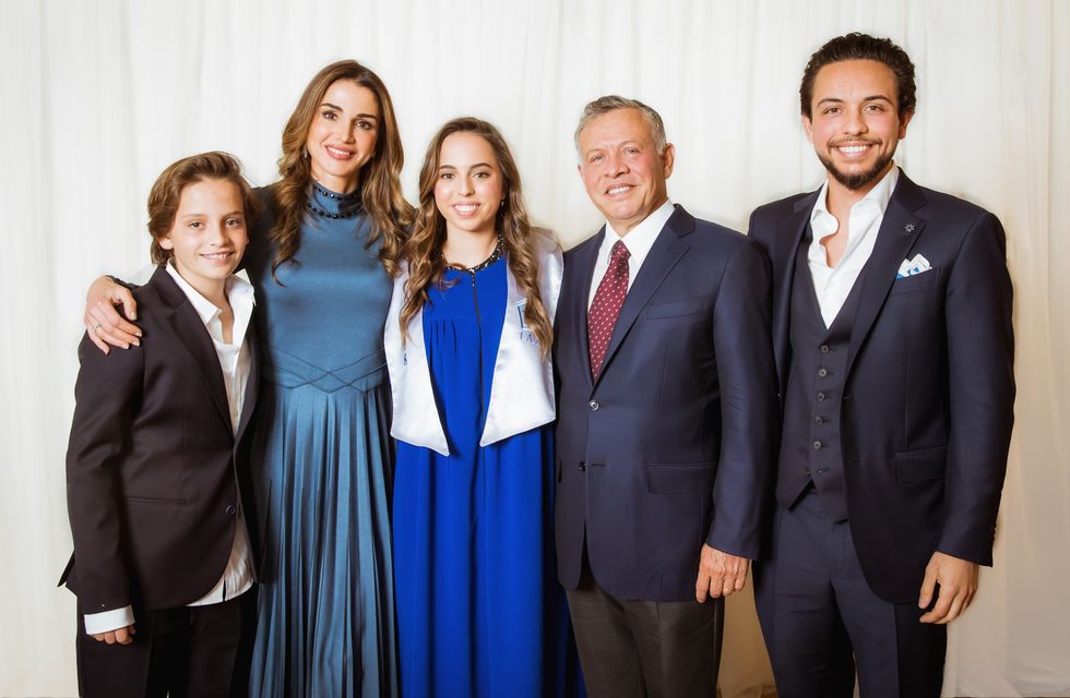 prince hashem, queen rania, princess salma, king abdullah ii, and crown prince hussein pose for a photo while smiling and standing together