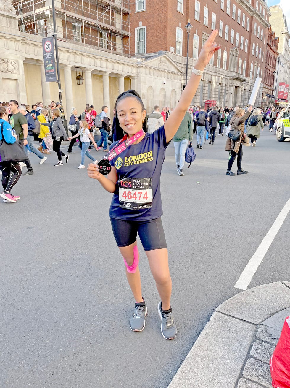 woman runner posing with a medal at the end of a race