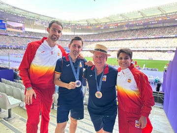 group of athletes with medals in a stadium