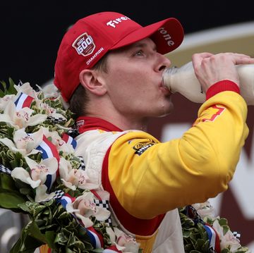 josef newgarden drinks from a pint of milk as he celebrates his indy 500 win