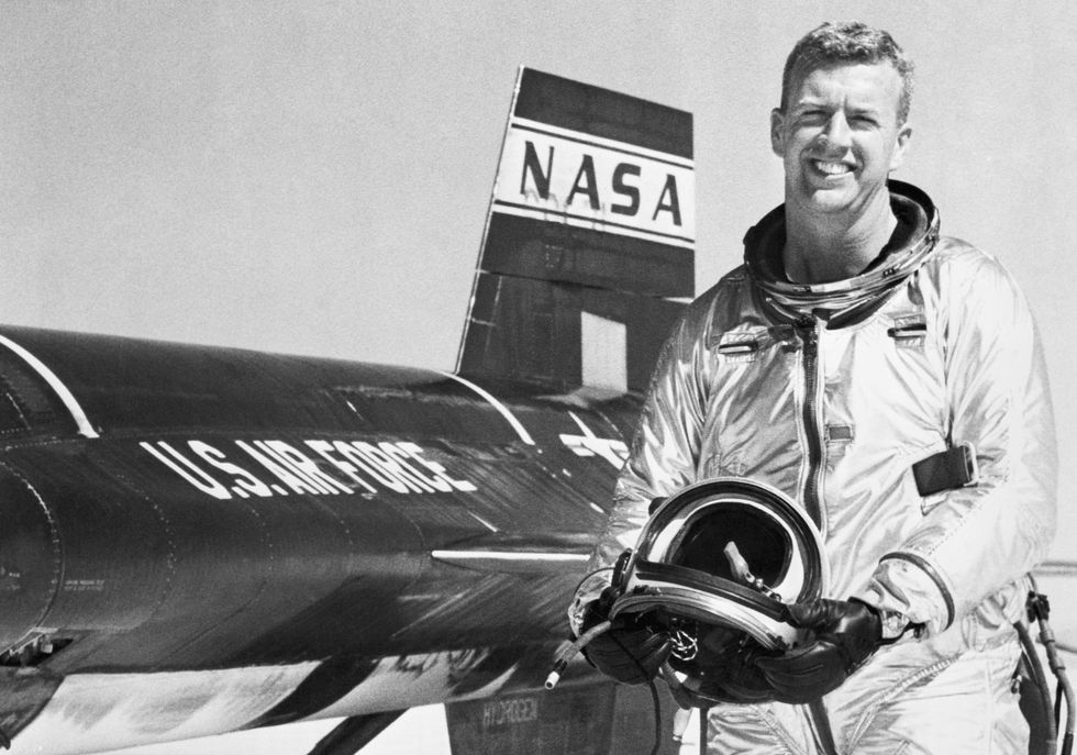 Joseph A. Walker smiles as he stands beside an X-15 rocket plane in which he flew at a record breaking altitude of 165,000 feet and a speed of 2,590 miles an hour. California.